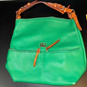 Dooney and Burke green leather purse with brown handle.